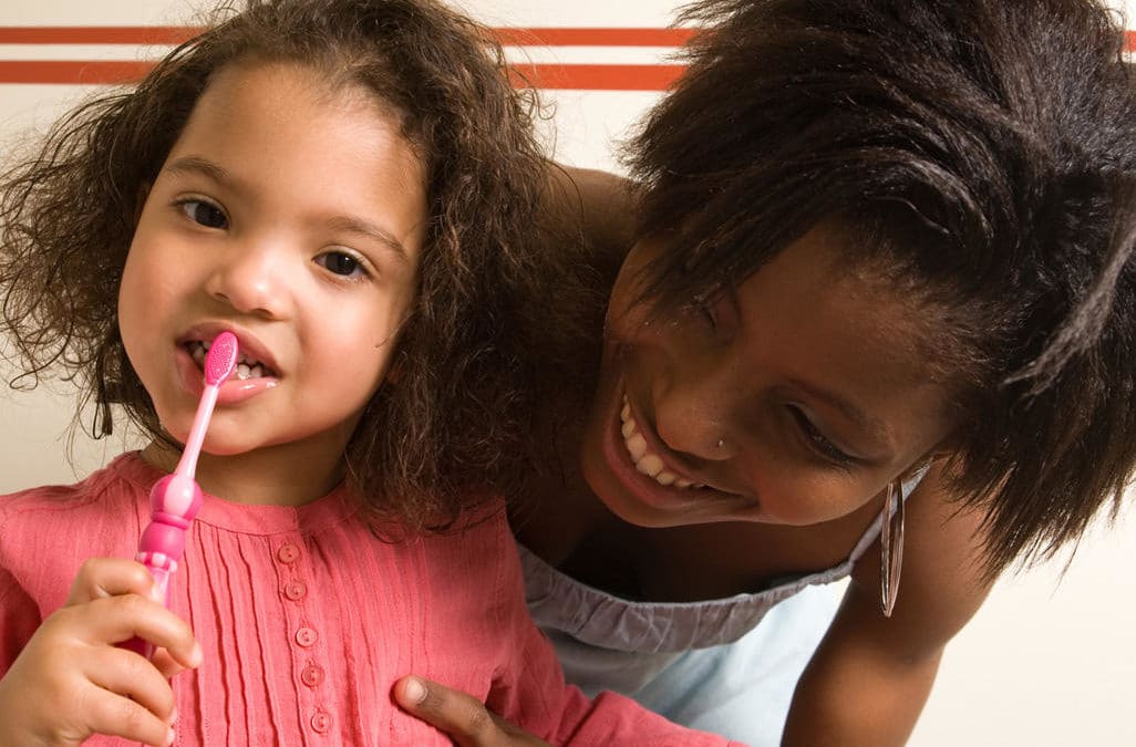 How can I get my toddler to cooperate when I brush her teeth?