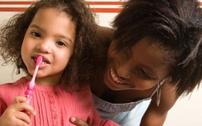 How can I get my toddler to cooperate when I brush her teeth?