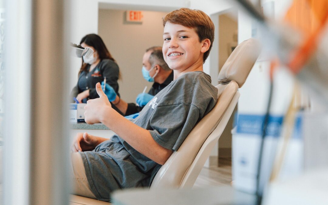 boy in dentist chair happy and cavity free